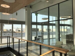 renovated modern stairwell leading up to a glass enclosed lobby space