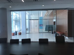 glass enclosed conference room with a large black conference table