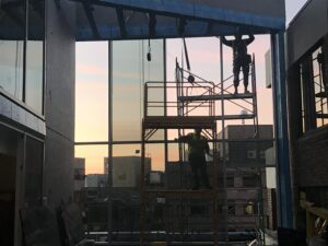 silhouettes of Ternion Builders workers working on windows