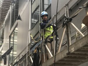 Ternion Builders employee working on the side of the 1441 Street N building