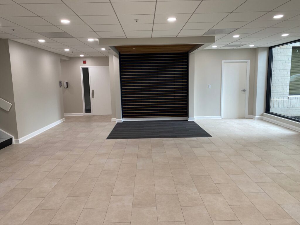 large renovated lobby area with linoleum flooring