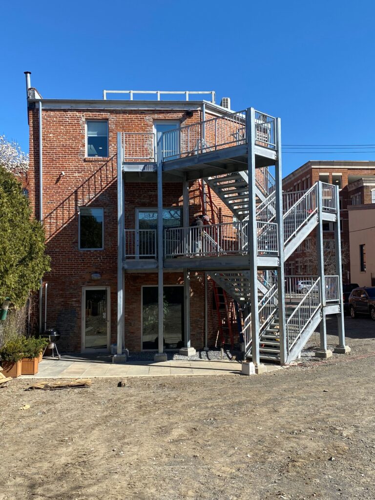 rear exterior of the ArachnidWorks building with a newly installed exterior stair case