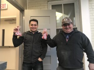 Ternion Builders contractors posing with plastic bags with candy