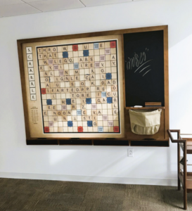 giant scrabble board wall art in a office space