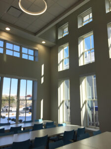 interior of a gathering area at ClearView Communities with multiple long table with chairs