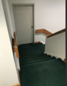 green carpeted stairs in the Phoenix Mecano office building