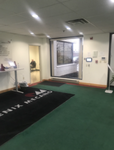 Phoenix Mecano lobby with green carpeting and branded black rug